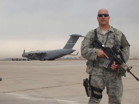 Tech. Sgt. Wilford Williams, 151st Security Forces Squadron, Utah Air National Guard, poses in front of a C-17 on a flightline in Iraq. Sergeant Williams is on a six-month deployment to Iraq with the 151st SFS to assist airbase defensive forces in support of Operation New Dawn. U.S. courtesy photo (Released)