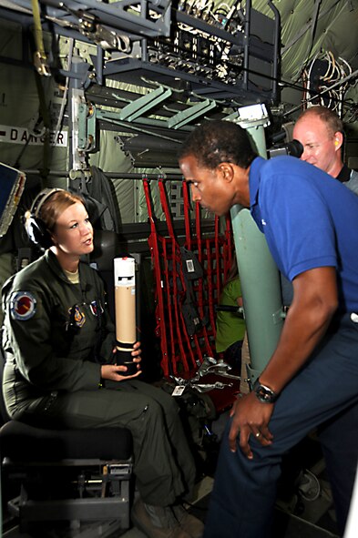 Senior Airman Jenna Tucker, 53rd Weather Reconnaissance Squadron loadmaster, explains to Damon Singleton, WDSU news team, how the dropsonde reads data after being deployed out of the C-130J. During Media Day the Hurricane Hunters were able to explain the mission and preparations that are made before the season begins. (U.S. Air Force Photo by Staff Sgt. Tabitha Dupas)