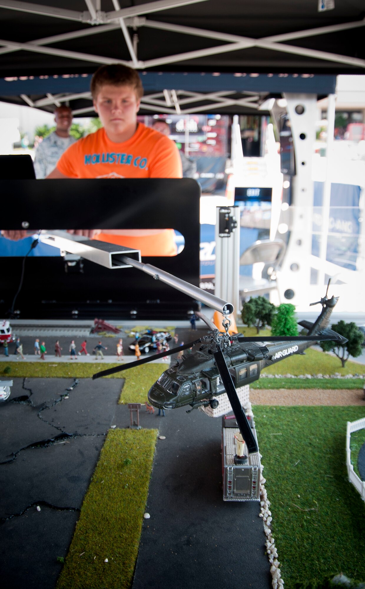 Cole Sherman of Morganfield, Ky., lowers a helocopter to "rescue" a stranded man in a scale model simulating a disaster torn city at the 2010 Kentucky State Fair,  The Simulator was part of the Kentucky Air National Guard Base Louisville's 123rd Airlift Wing "Rise to the Challenge" tour.  The activities of the tour featured hands-on challegnes to educate the public, highlight the benfits of service, and identify opportunities that could help prospective Bluegrass Airmen achieve their educational and career goals. (U.S. Air Force photo by Tech. Sgt. D. Clare)