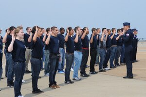Lt. Col Case Cunningham, U.S. Air Force Demonstration Squadron, the Thunderbirds, commander, administers the oath of enlistment to 45 of Hampton Roads’ newest members of the Air Force Delayed Entry Program at Langley Air Force Base, Va., May 14, 2011. The recruits accepted the call to service at the Joint Base Langley-Eustis Airpower over Hampton Roads open house. (U.S. Air Force photo/Senior Airman Antoinette Gibson) (RELEASED)