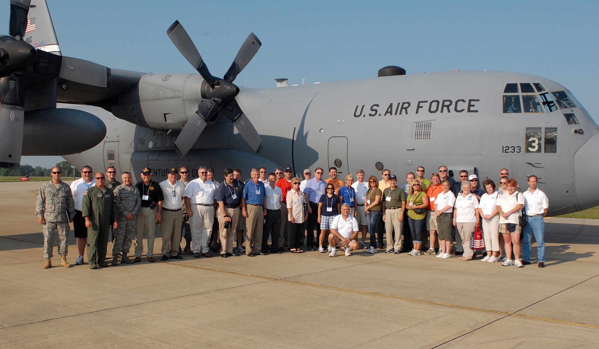Kentucky civic leaders and employers pause before a Kentucky Air National Guard C-130 cargo transport plane from the 123rd Airlift Wing, Louisville, Ky., at Fort Knox, Ky., during "Boss Lift" Aug. 13, 2010.  The event, sponsored by Employers Support of the Guard and Reserve, is designed to foster support and understanding of the duties, training, and military life National Guard and Reserve troops experience. (Photo by Army Spc. Scott Raper)
