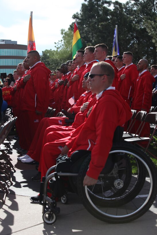 U.S. Marines stand at attention during the playing of the Marines Hymn during the Opening Ceremony of the 2011 Warrior Games at the Olympic Training Center in Colorado Springs, Colo. MAY 16, 2011. The All-Marine Team will compete against the other military branches in various events including wheelchair basketball, sitting volleyball, and cycling.