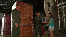A girl scout from the North Carolina Coastal Pines region helps personally deliver cookies to Airmen of the 911th Air Refueling Squadron that are preparing to deploy. Nearly 1,200 boxes of cookies were donated to Seymour Johnson for troops heading overseas. (USAF photo by MSgt. Wendy Lopedote, 916ARW/PA)