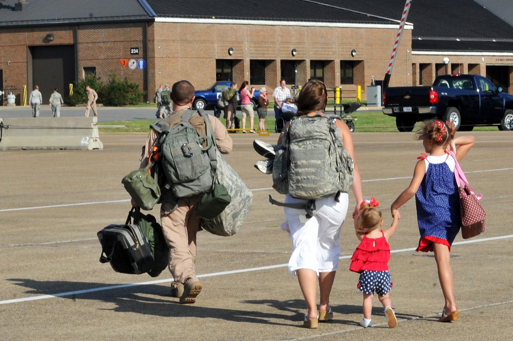 Staff Sgt. John Carlin, 61st Airlift Squadron, walks off the fightline with his family May 13, 2001, on Little Rock Air Force Base Ark.  Sergeant Carlin was one of 50 61st AS Airmen who returned from operations at Joint Base Balad, Iraq. (U.S. Air Force photo/Staff Sgt. Chris Willis)