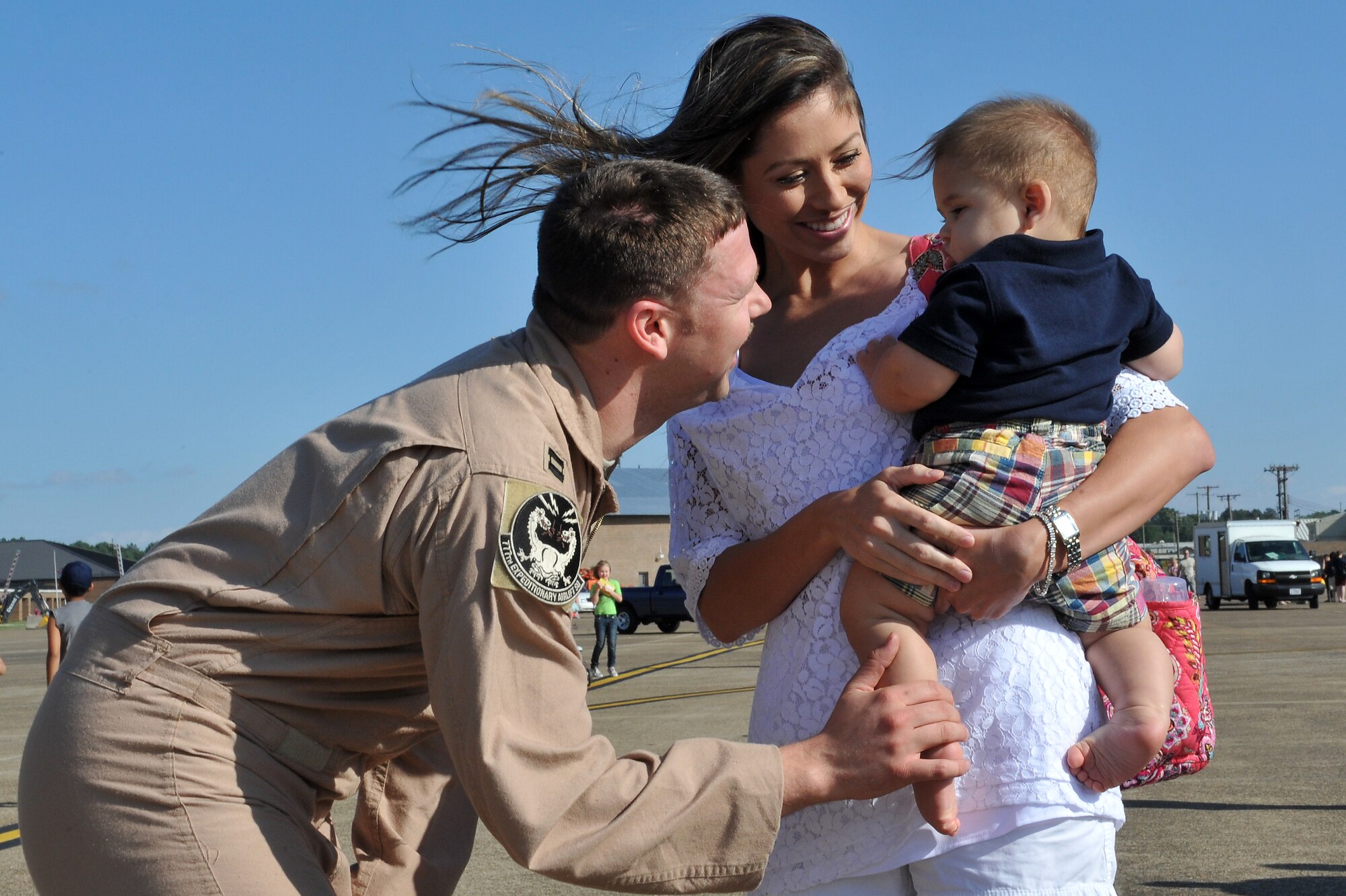 Capt. Christopher Lang, 61st Airlift Squadron, is greeted by his wife, Emmalee; and son, Luke; on the flightline May 13, 2001, on Little Rock Air Force Base Ark.  Captain Lang along with other deployed members flew missions including airdrop and aeromedical evacuation. (U.S. Air Force photo/Staff Sgt. Chris Willis)
