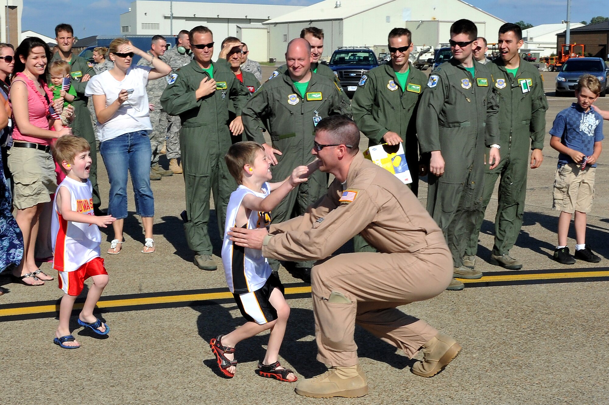 Tech. Sgt. David Hendrickson, 61st Airlift Squadron, is greeted with open arms by his sons, Aiden and Karsten, May 13, 2001, on Little Rock Air Force Base Ark. While deployed, Sergeant Hendrickson and other deployed members flew missions including airdrop and aeromedical evacuation. (U.S. Air Force photo/Staff Sgt. Chris Willis)