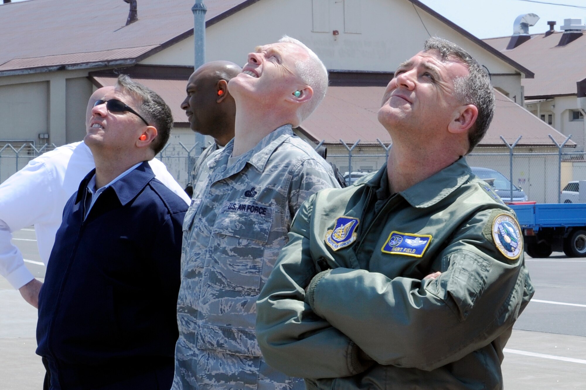 MISAWA AIR BASE, Japan -- Lt. Gen. Burton Field, U.S. Forces Japan and 5th Air Force commander, right, along with Chief Master Sgt. Andy Kaiser, USFJ and 5th AF command chief, center, and Chief Master Sgt. Russell Hastings, 35th Fighter Wing command chief, watch an F-16 Fighting Falcon Demonstration Certification show May 16. The demo team must be certified by a numbered air force or major command commander before being allowed to perform. (U.S. Air Force photo/Staff Sgt. Marie Brown/Released)