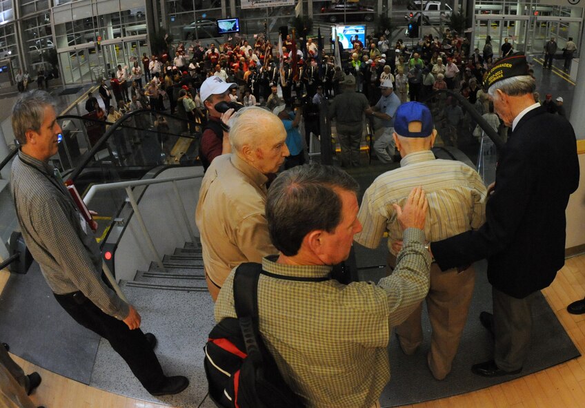World War II veterans receive a pleasant "welcome home" after returning from a trip to Washington D.C. at the Shreveport Regional Airport in Shreveport, La., May 12. The veterans visited the capital to see the World War II monument for their first time. Barksdale and the local community welcomed the veterans home to show support and gratitude. (U.S. Air Force photo/Airman 1st Class Micaiah Anthony)(RELEASED)