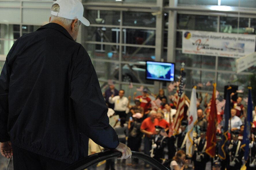 A World War II veteran receives a pleasant "welcome home" at the Shreveport Regional Airport in Shreveport, La., May 12. Barksdale Airmen and citizens of the local Shreveport/Bossier community welcomed the veterans home from their trip to Washington D.C. The veterans got the opportunity to view their memorial for the first time. (U.S. Air Force photo/Airman 1st Class Micaiah Anthony)(RELEASED)