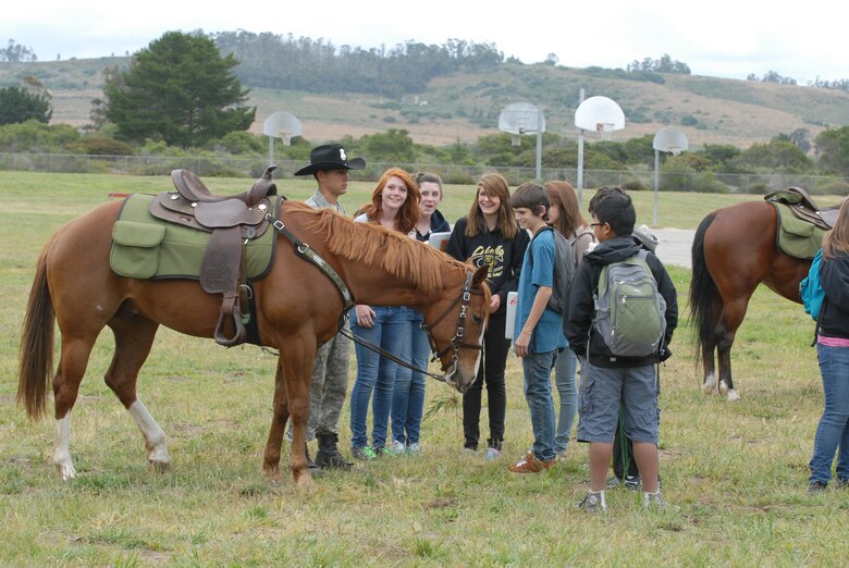VANDENBERG AIR FORCE BASE, Calif. -- Airman 1st Class Zach Baldenegro, a 30th Security Forces Squadron mounted horse patrolman, explains to Vandenberg Middle School students what he and his horse, Snickers, do at a National Police Week event Monday, May 16, 2011. National Police Week, which occurs annually during the week of May 15, recognizes the service and sacrifice of U.S. law enforcement personnel. (U.S. Air Force photo/Jerry E. Clemens, Jr.)