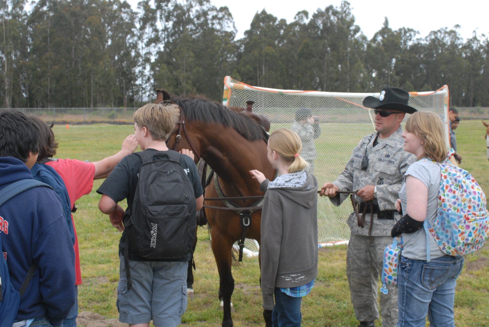 VANDENBERG AIR FORCE BASE, Calif. -- Tech. Sgt. Sean Yargus, a 30th Security Forces Squadron mounted horse patrolman, explains to Vandenberg Middle School students what he and his horse, Trooper, do at a National Police Week event Monday, May 16, 2011. National Police Week, which occurs annually during the week of May 15, recognizes the service and sacrifice of U.S. law enforcement personnel. (U.S. Air Force photo/Jerry E. Clemens, Jr.)