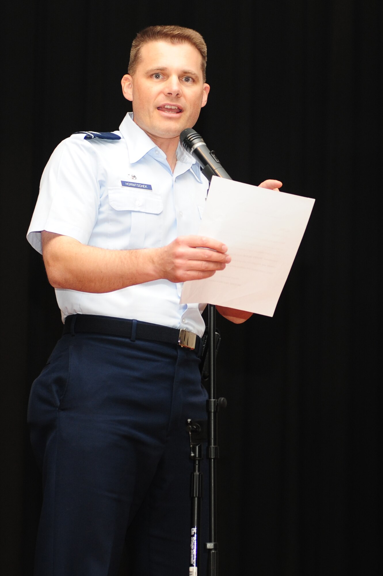 Col. Michael Hornitschek, 375th Air Mobility Wing commander, introduces comedian Bernie McGrenahan prior to his performance May 16, 2011 at Scott Air Force Base, Ill. The show, Happy Hour comedy tour, provided comedy with a twist as a safety and prevention message was given along with the laughs. (U.S. Air Force photo by Staff Sgt. Teresa Jennings)
