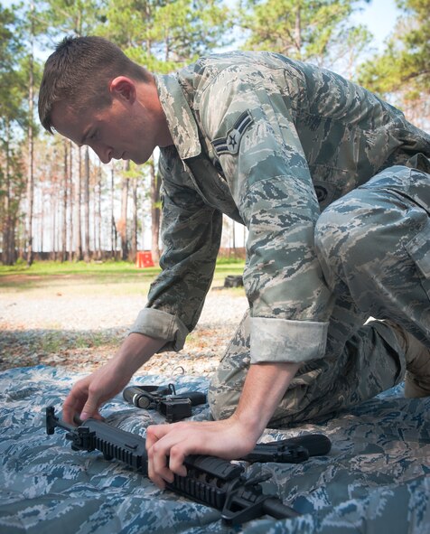 MOODY AIR FORCE BASE, Ga -- Airman 1st Class Kyle Selsor, 822nd Base Defense Squadron fire team member, reassembles an M4 assault rifle during the weapons breakdown and assembly portion of the Warrior Challenge May 14. Each participant was timed while breaking down and assembling an M4 and an M9 pistol.  (U.S. Air Force photo/ Airman 1st Class Jarrod Grammel)(RELEASED)