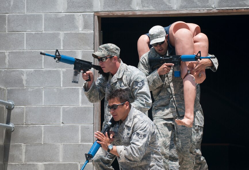 MOODY AIR FORCE BASE, Ga -- Airmen of the 823rd Base Defense Squadron exfiltrate a building with a simulated casualty during a military operations in urban terrain scenario May 13. The teams were required to engage all targets and extract a simulated casualty, a 200 pound dummy. (U.S. Air Force photo/ Airman 1st Class Jarrod Grammel)(RELEASED)