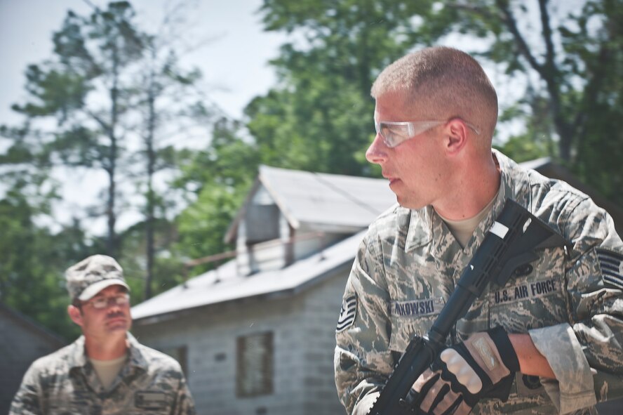 MOODY AIR FORCE BASE, Ga -- Tech. Sgt. Kurt Pinkowski, 23rd Security Forces Squadron investigator, watches his teammates’ backs while infiltrating a building during a military operations in urban terrain scenario May 13. The scenario required the teams to engage objects labeled with different numbers, representing friendly inhabitants and hostile targets. (U.S. Air Force photo/ Airman 1st Class Jarrod Grammel)(RELEASED)