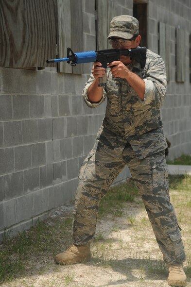 MOODY AIR FORCE BASE, Ga. -- Airman 1st Class Nicholas Koch, 822nd Base Defense Squadron, holds his position while providing support for his team as they extract a simulated hostage May 13. Airman Koch was part of a four-man assembled team competing in a time-based competition against four other security forces teams. (U.S. Air Force photo/Airman 1st Class Paul Francis)(RELEASED)
