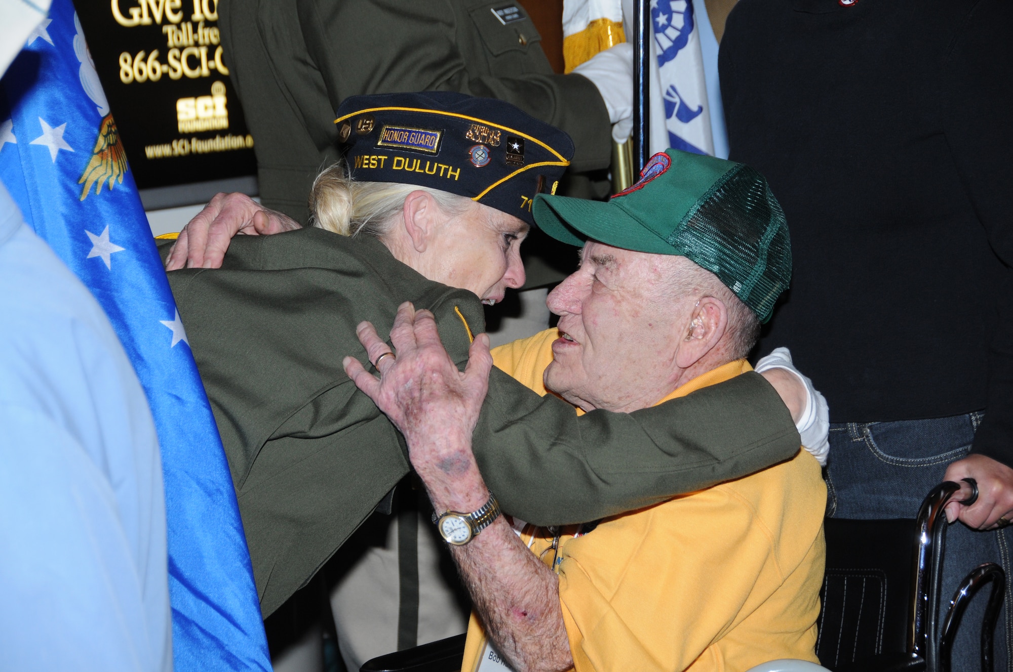 A World War II veteran gets a hug before departing the Duluth International Airport, Duluth, Minn.  The veteran was waiting to board an aircraft going to Washington D.C. as part of the Northland Honor Flight.  (U.S. Air Force photo by Master Sgt. Ralph J. Kapustka)