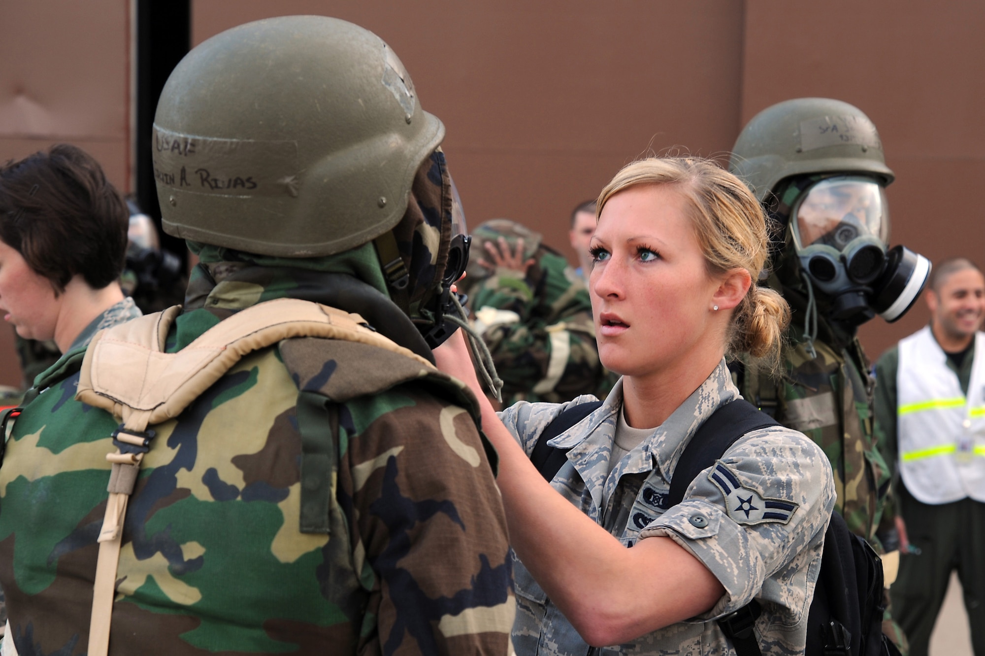 Second Lt. Edwin Rivas, 22nd Force Support Squadron plans and programs officer in charge, gas mask is inspected by Airman 1st Class Nicole Schlamann, 22nd Civil Engineer Squadron readiness and emergency management journeyman, during an operational readiness exercise training scenario May 12, 2011, McConnell Air Force Base, Kan. ORE’s ensure that all Team McConnell members are capable of performing their duties in wartime conditions. (U.S. Air Force photo/Staff Sgt. Dallas Edwards)
