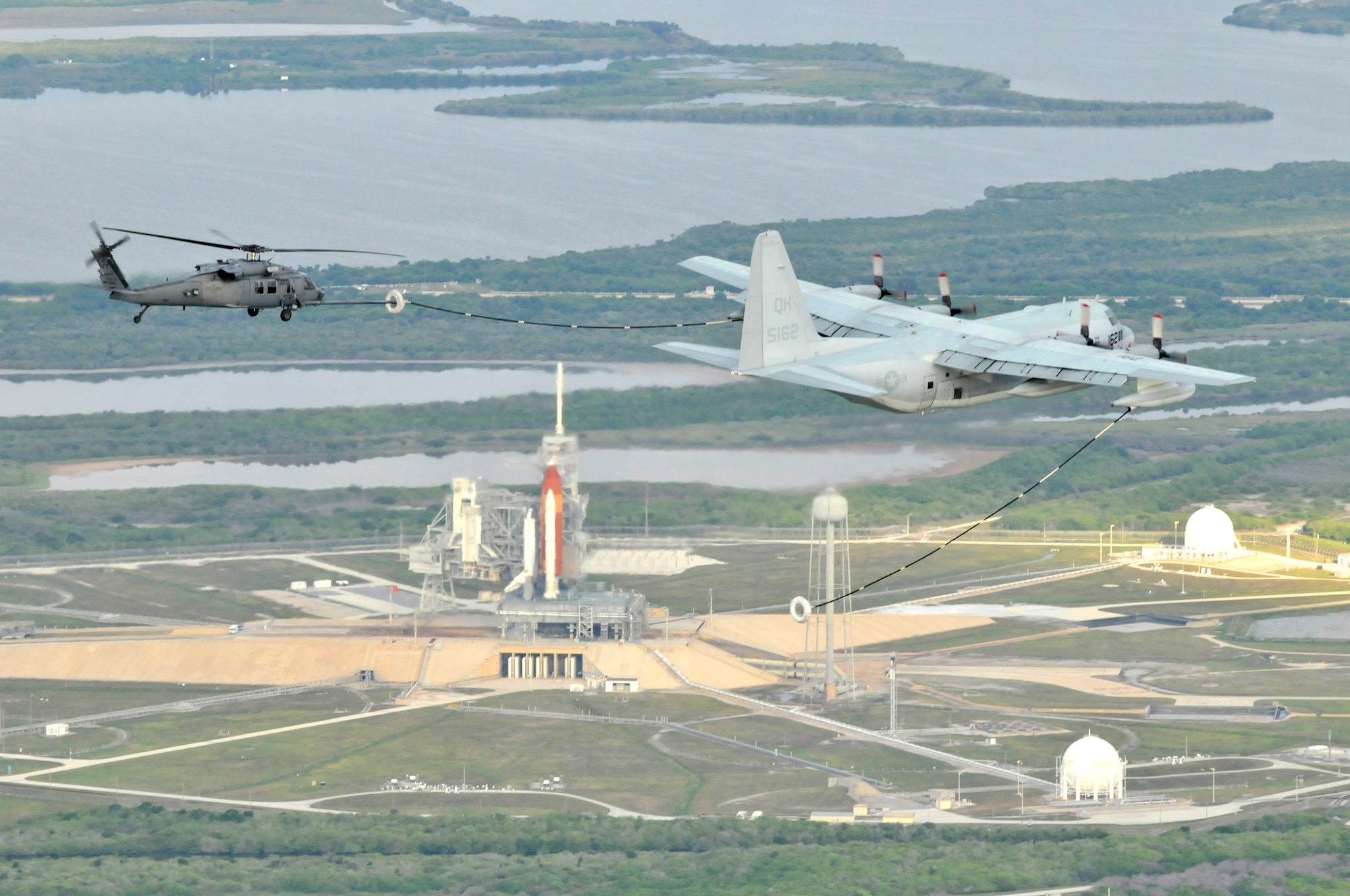 PATRICK AIR FORCE BASE, Fla. - A U.S. Marine HC-130 King refuels a 920th Rescue Wing HH-60G Pave Hawk to ensure it's fueled up in case it must launch for an emergency during Space Shuttle Endeavor's last lift off May 16, 2011. (U.S. Air Force photo/Staff Sgt. Anna-Marie Wyant)