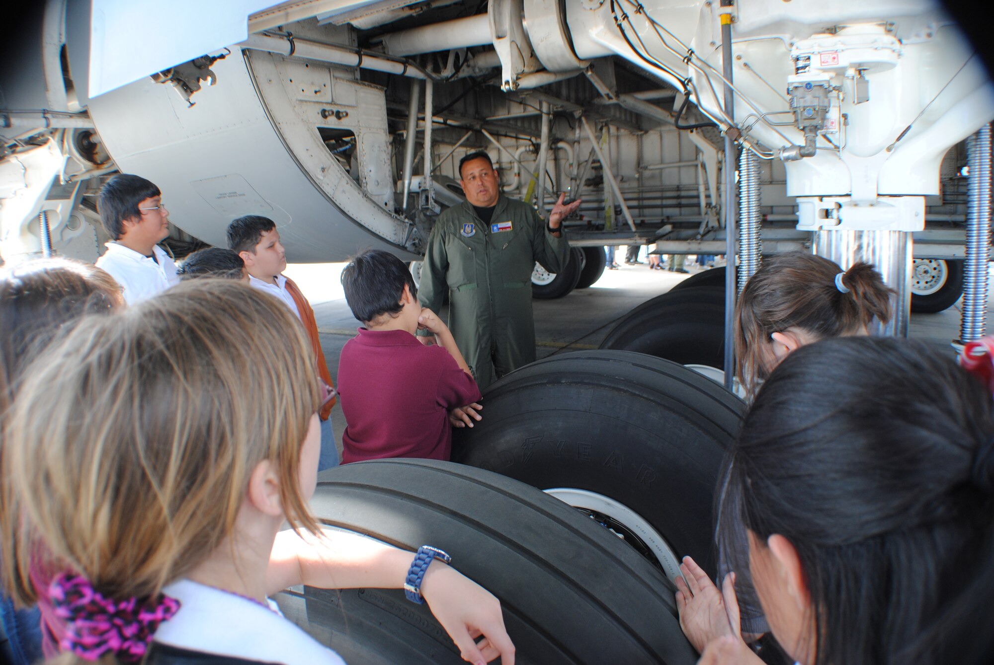 Tech. Sgt. Jim Alcido, 68th Airlift Squadron flight engineer, talks about how hydraulic power is used on the breaking and wheel systems of a C-5 Galaxy, while serving as a tour guide for a group of sixth graders from Devine Middle School. More than 120 middle school students and their teachers visited the 433rd Airlift Wing as part of a field trip to Lackland Air Force Base, Texas May 16. (U.S. Air Force photo/Senior Airman Luis Loza Gutierrez)