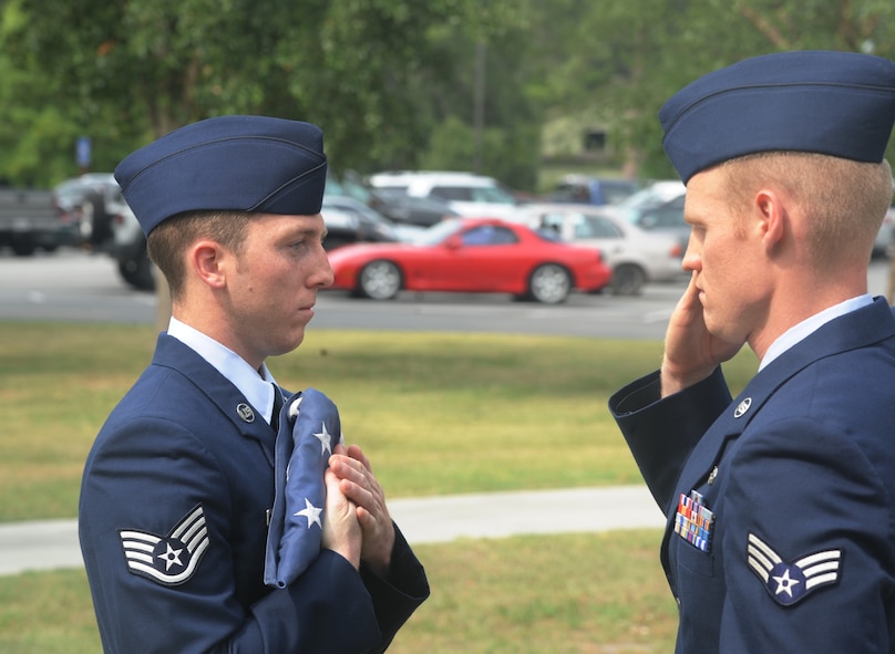 Staff Sgt. Christopher Matthews and Senior Airman Austin Strabala, Airman Leadership School Class 11-E students, retire the American flag May 13 during a National Police Week Retreat Ceremony held at Moody Air Force Base, Ga.  Sergeant Matthews and Airman Strabala were two of three ALS students who took part in the ceremony. (U.S. Air Force photo/Airman 1st Class Paul Francis)(RELEASED)