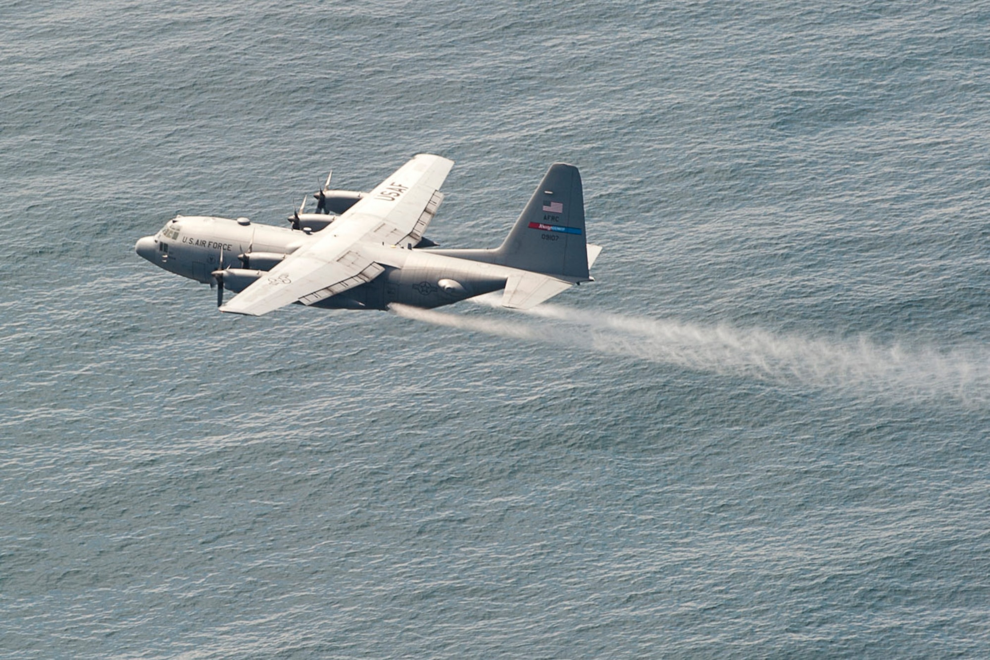 SOMEWHERE OFF THE CALIFORNIA COAST -- The Air Force Reserve's 910th Airlift Wing, the U.S. Coast Guard  and more than 35 other organizations are participating in a multi-agency oil spill response exercise near the San Diego coast, May 11-12, 2011.  A specially-equipped 910th C-130H Hercules cargo aircraft sprays a practice dispersant, actually water, onto the simulated oil spill as part of the response here, May 12, 2011.The 910th AW operates the Department of Defense's only large-area, fixed wing aerial spray capability. The 910th's C-130 aircrew is highly trained to complete this unique low-altitude, high-speed mission. Participants in the exercise returned to their various home stations on May 13, 2011. U.S. Air Force photo by Mr. Eric White