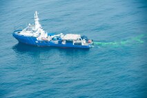 SOMEWHERE OFF THE CALIFORNIA COAST -- The Air Force Reserve's 910th Airlift Wing, the U.S. Coast Guard  and more than 35 other organizations are participating in a multi-agency oil spill response exercise near the San Diego coast, May 11-12, 2011. The sea vessel, California Responder, pours a non-toxic green dye into the ocean to simulate a 1.5 million gallon oil spill as part of the event here, May 12, 2011. The 910th AW operates the Department of Defense's only large-area, fixed wing aerial spray capability and will spray a practice dispersant, actually water, onto the simulated oil spill as part of the response . Participants in the exercise returned to their various home stations on May 13, 2011. U.S. Air Force photo by Mr. Eric White
