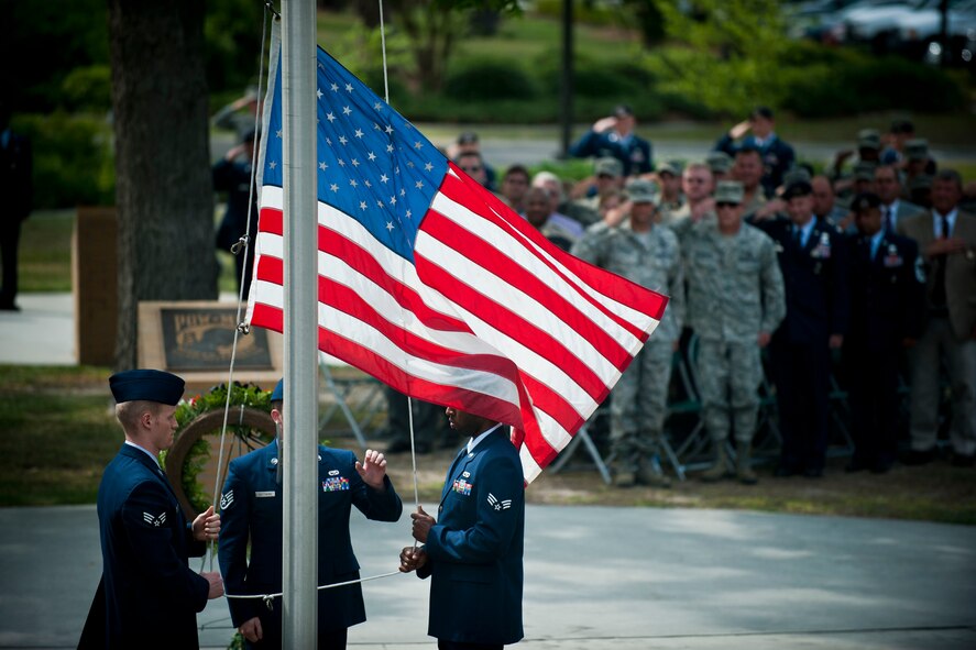 Senior Airman Gerard Clarke, Staff Sgt. Christopher Matthews and Senior Airman Austin Strabala, Airman Leadership School Class 11-E students, retire the American flag during a National Police Week Retreat Ceremony May 13 at Moody Air Force Base, Ga. The ceremony offered a time to honor law enforcement officers who paid the ultimate sacrifice by giving their lives in the line of duty. (U.S. Air Force photo/Staff Sgt. Jamal D. Sutter)(RELEASED)