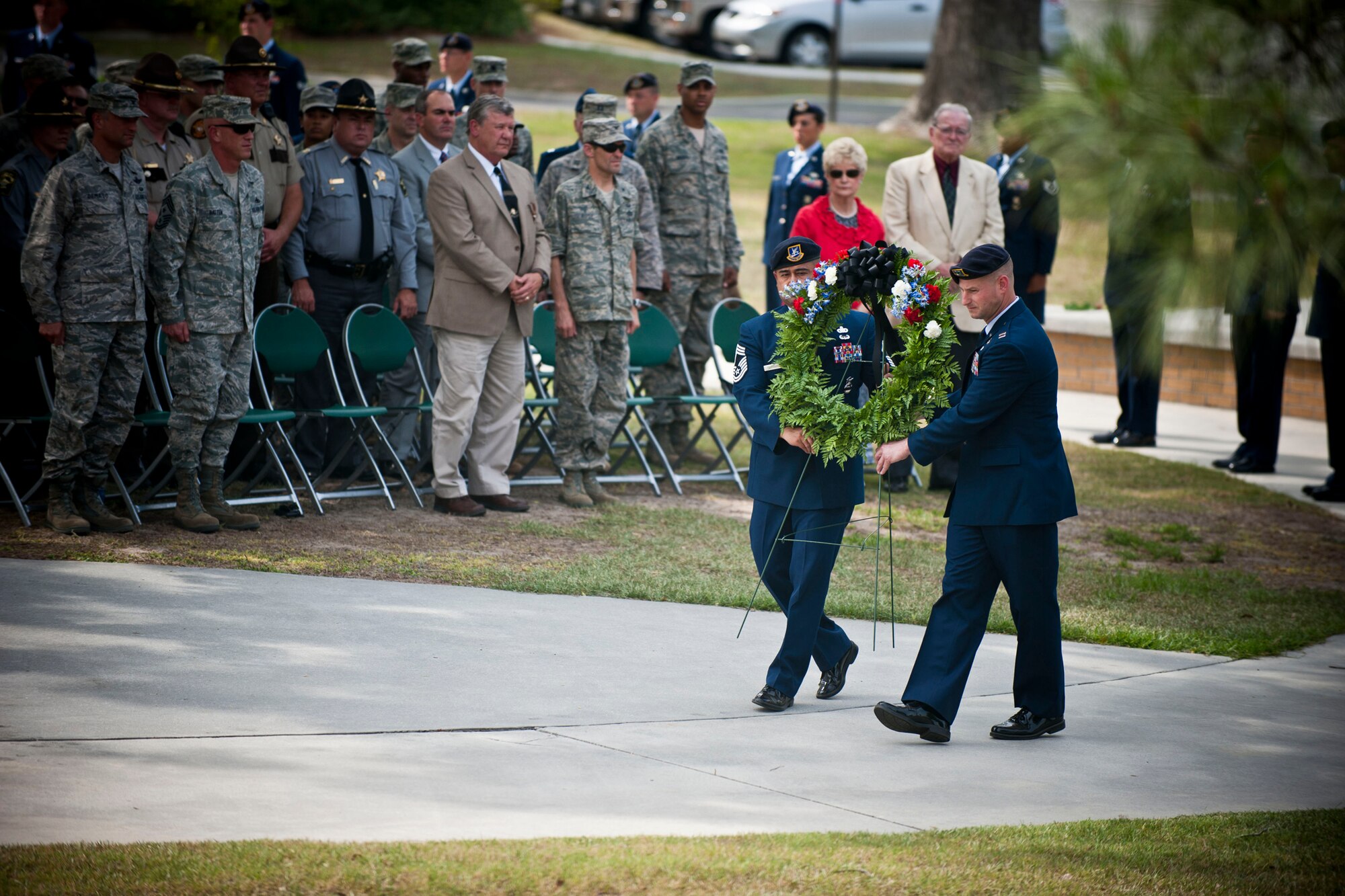 Chief Master Sgt. Joseph Pritchard, 23rd Security Forces Squadron security forces manager, and Capt. Justin Secrest, 23rd SFS commander, prepare a ceremonial wreath for roll call during a National Police Week Retreat Ceremony May 13 at Moody Air Force Base, Ga. The ceremony was a way to recognize and honor law enforcement officers who have fallen in the line of duty. (U.S. Air Force photo/Staff Sgt. Jamal D. Sutter)(RELEASED)