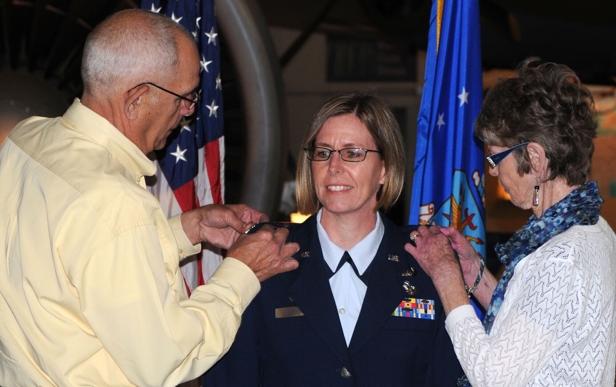 Bob and Kris Wiltse pin on the rank of colonel to their daughter Gretchen M. Wiltse May 13 during a promotion ceremony at the Air Mobility Command Museum. Colonel Wiltse is the 512th Mission Support Group commander. (U.S. Air Force photo by Capt. Marnee A.C. Losurdo/Released)