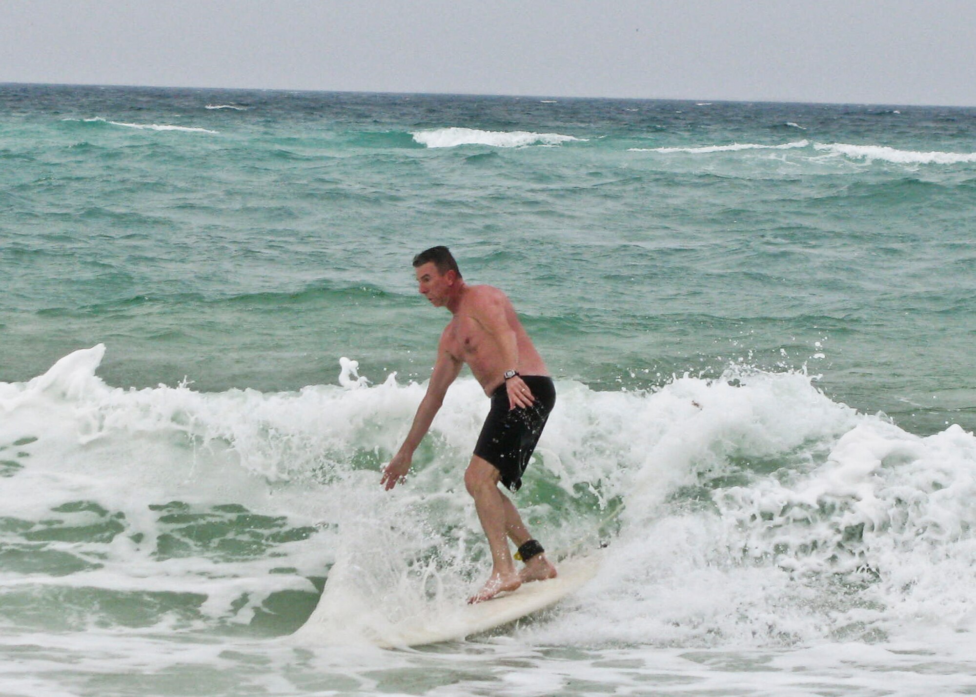 Chief Master Sgt. Tom Westermeyer, 96th Air Base Wing command chief, rides a wave at the Okaloosa Island Boardwalk May 13.  The chief will end his 30-year career at Eglin in June, when he officially retires from Air Force active duty.  (U.S. Air Force photo/Irene Freiberg.)