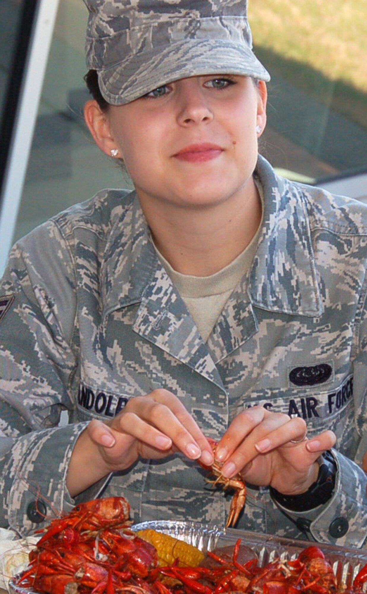 Senior Airman Crystal Randolph, Headquarters Eighth Air Force, eats crawfish during the 608th Strategic Operations Squadron crawfish boil at the Cyber Innovation Center in Bossier City, La., May 13. Crawfish season in Louisiana begins in March and continues through July. Louisiana supplies 98 percent of the crawfish harvested in the United States. (U.S. Air Force photo/Staff Sgt. Brian Stives)