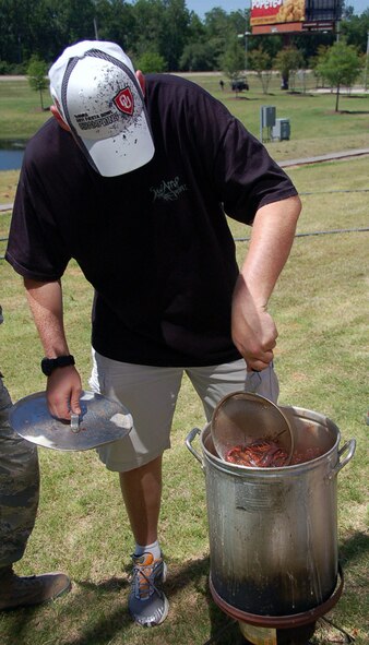 Tech. Sgt. Steven Davis, 608th Strategic Operations Squadron, stirs crawfish in a pot during the 608th STOS crawfish boil at the Cyber Innovation Center in Bossier City, La., May 13. Crawfish season in Louisiana begins in March and continues through July. Louisiana supplies 98 percent of the crawfish harvested in the United States. (U.S. Air Force photo/Staff Sgt. Brian Stives)