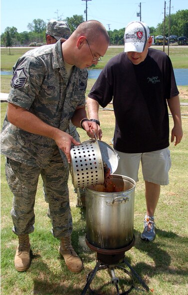 Master Sgt. Robert Reeder and Tech. Sgt. Steven Davis, both from the 608th Strategic Operations Squadron, prepare to boil crawfish during the 608th STOS crawfish boil at the Cyber Innovation Center in Bossier City, La., May 13. Crawfish season in Louisiana begins in March and continues through July. Louisiana supplies 98 percent of the crawfish harvested in the United States. (U.S. Air Force photo/Staff Sgt. Brian Stives)