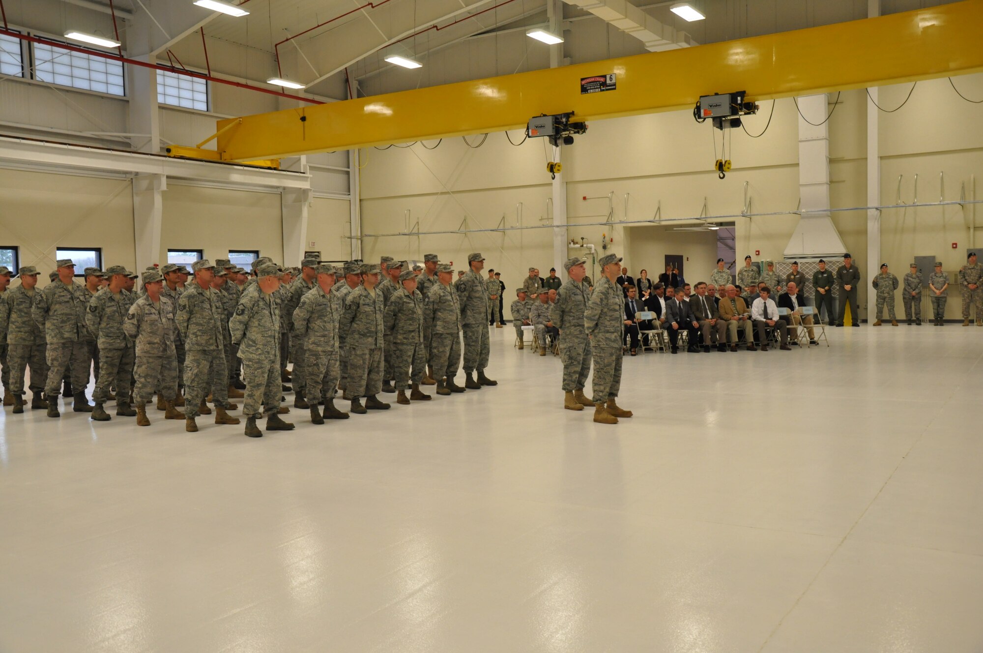 A formation of members from the Connecticut Air National Guard's 103rd Maintenance Group and seated guests look on during a ribbon cutting ceremony April 28, 2011, to mark the official opening of the Centralized Repair Facility at Bradley Air National Guard Base, East Granby, Conn. (Photo by Sgt. 1st Class Debbi Newton, State Public Affairs NCO)