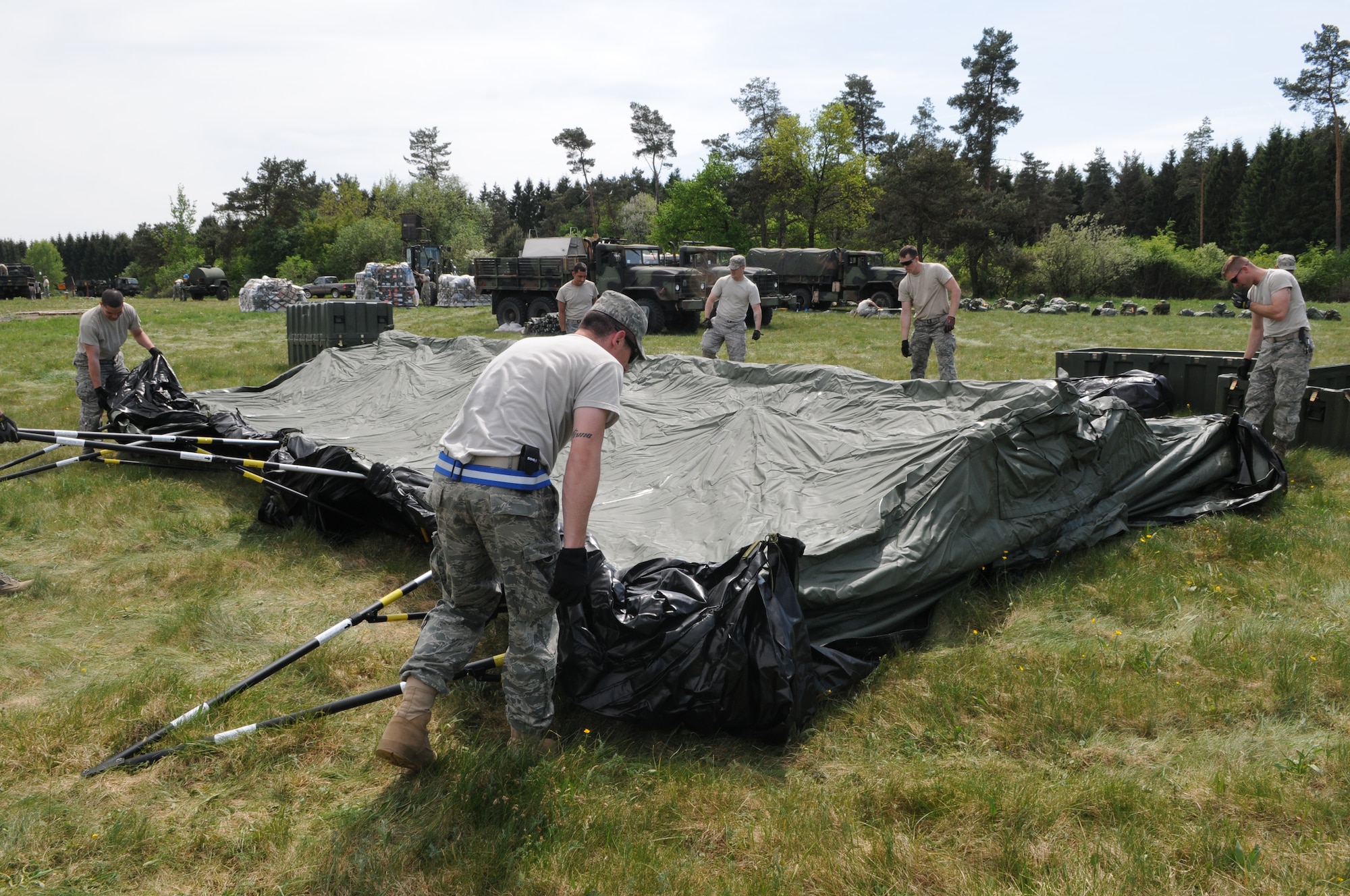 GEROLSTEIN, Germany – Airmen from the 606th Air Control Squadron move and build a tent after arriving to an isolated location as part of exercise Eifel Thunder 2011 in Gerolstein, Germany, May 9. The exercise tested the ability of Airmen to take all their equipment to an isolated location where they set up a deployed radar and satellite communications site as well as everything else required to survive and accomplish the mission in an isolated environment. (U.S. Air Force photo/Senior Airman Nick Wilson)