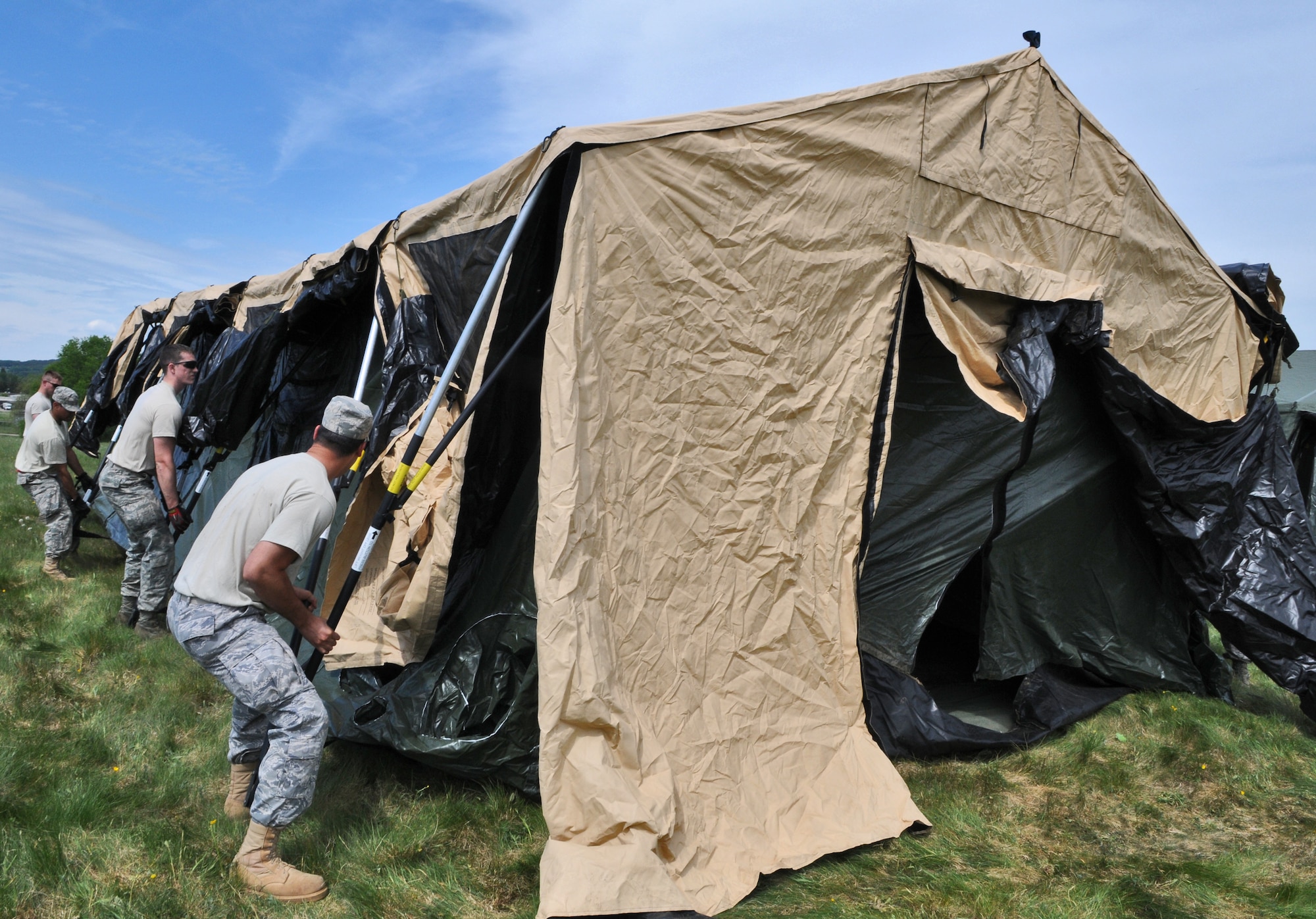 GEROLSTEIN, Germany – Airmen from the 606th Air Control Squadron move and build a tent after arriving to an isolated location as part of exercise Eifel Thunder 2011 in Gerolstein, Germany, May 9. The exercise tested the ability of Airmen to take all their equipment to an isolated location where they set up a deployed radar and satellite communications site as well as everything else required to survive and accomplish the mission in an isolated environment. (U.S. Air Force photo/Senior Airman Nick Wilson)