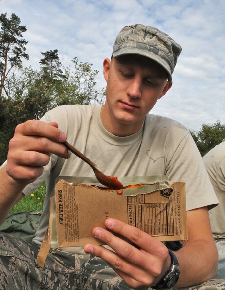 GEROLSTEIN, Germany – Senior Airman Andrew Bastic, 606th Air Control Squadron power production apprentice, eats a chili and bean “Meal, Ready to Eat” after arriving at the squadron’s “deployed” location as part of exercise Eifel Thunder 2011 in Gerolstein, Germany, May 9. The exercise tested the Airmen’s ability  to take all their equipment to a deployed location and set up a deployed radar and satellite communications site as well as everything else required to survive and accomplish the mission. (U.S. Air Force photo/Senior Airman Nick Wilson)