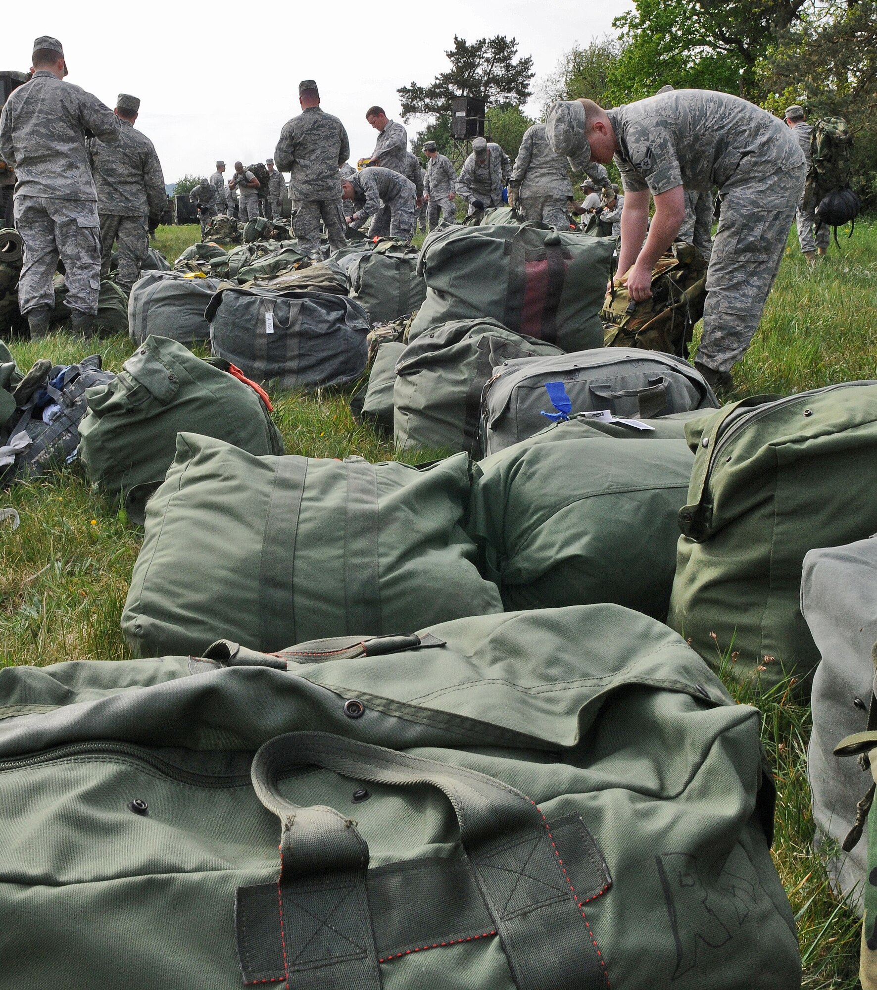 GEROLSTEIN, Germany – Airmen from the 606th Air Control Squadron organize their luggage after arriving at their “deployed” location as part of exercise Eifel Thunder 2011 in Gerolstein, Germany, May 9. The exercise tested the Airmen’s ability to take all their equipment to a deployed location and set up a deployed radar and satellite communications site as well as everything else required to survive and accomplish the mission. The squadron returned to Spangdahlem Air Base May 16. (U.S. Air Force photo/Senior Airman Nick Wilson)