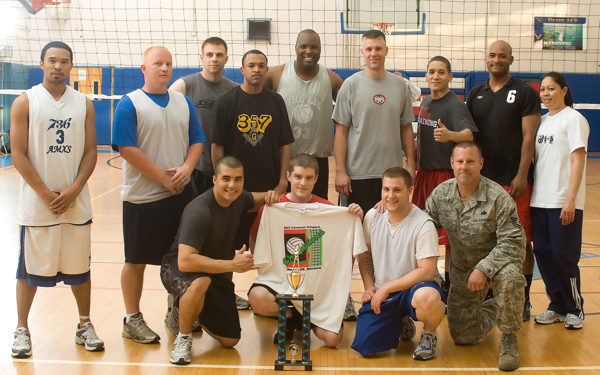 The 736th Aircraft Maintenance Squadron team poses with their trophy after the volleyball championship May 11, 2011, at the Dover Air Force Base, Del., Fitness Center. The 736 AMXS team defeated the 436th Logisistics Readiness Squadron after three games, with a final match score of 15-10. (U.S. Air Force photo by Airman 1st Class Matthew Hubby)