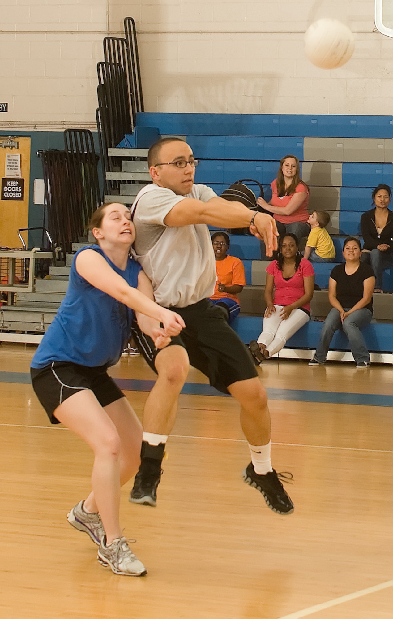 Zomora Diego (right) barrels into Jackie Rickie while passing a volleyball during the volleyball championship game May 11, 2011, at the Dover Air Force Base, Del., Fitness Center. Both are members of the 436th Logistics Readiness Squadron, which lost the final game of the championship game to the 736th Aircraft Maintenance Squadron 10-15. (U.S. Air Force photo by Airman 1st Class Matthew Hubby)
