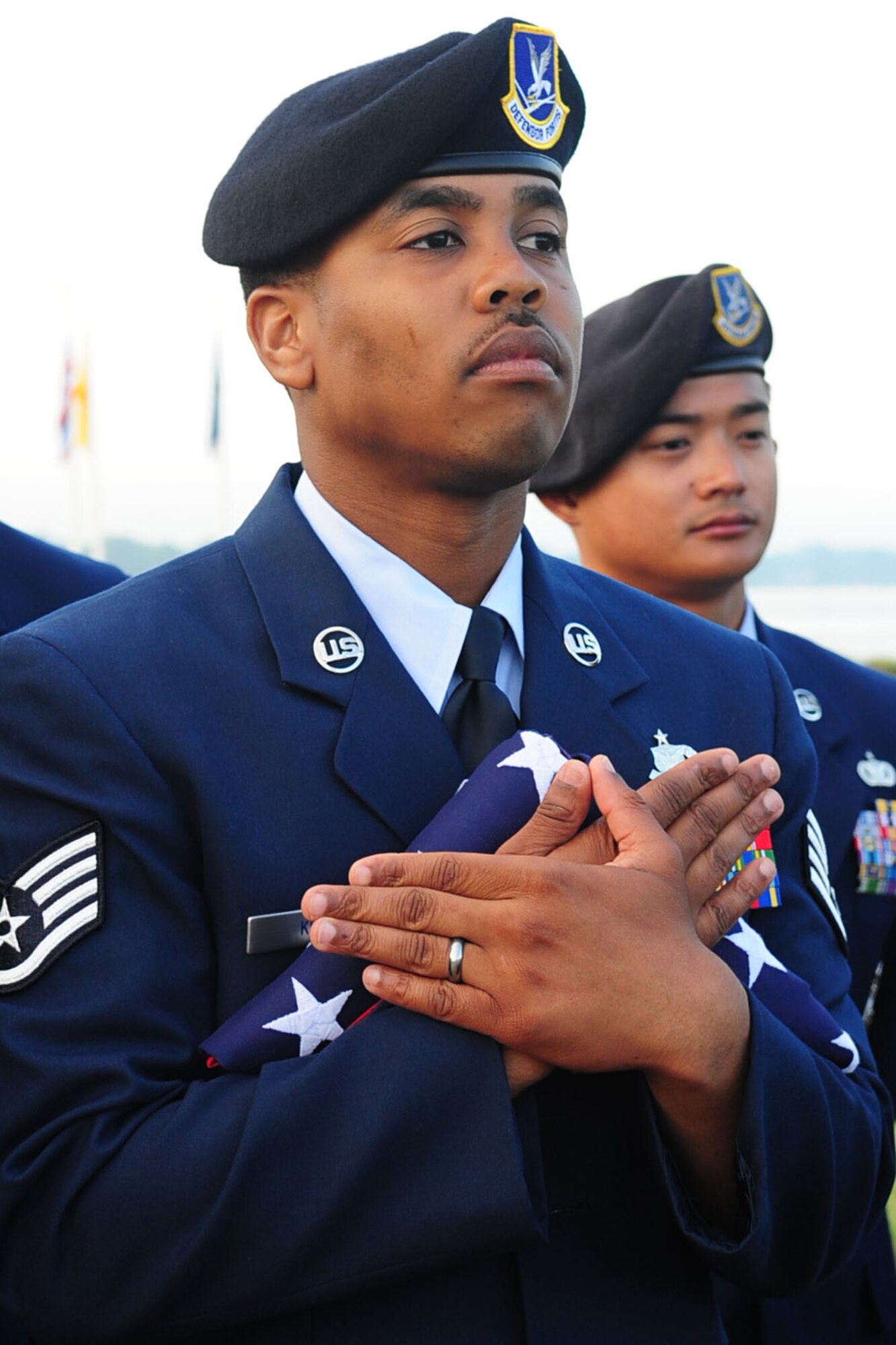 Staff Sgt. Marquin King, 633d Security Forces Squadron patrolman, holds the U.S. flag during the Police Officers' Memorial ceremony at Langley Air Force Base, Va., May 16, 2011. The ceremony was part of the National Police Week celebration, paying tribute to law enforcement officers who lost their lives in the line of duty. (U.S. Air Force photo by Staff Sgt. Ashley Hawkins)(RELEASED)