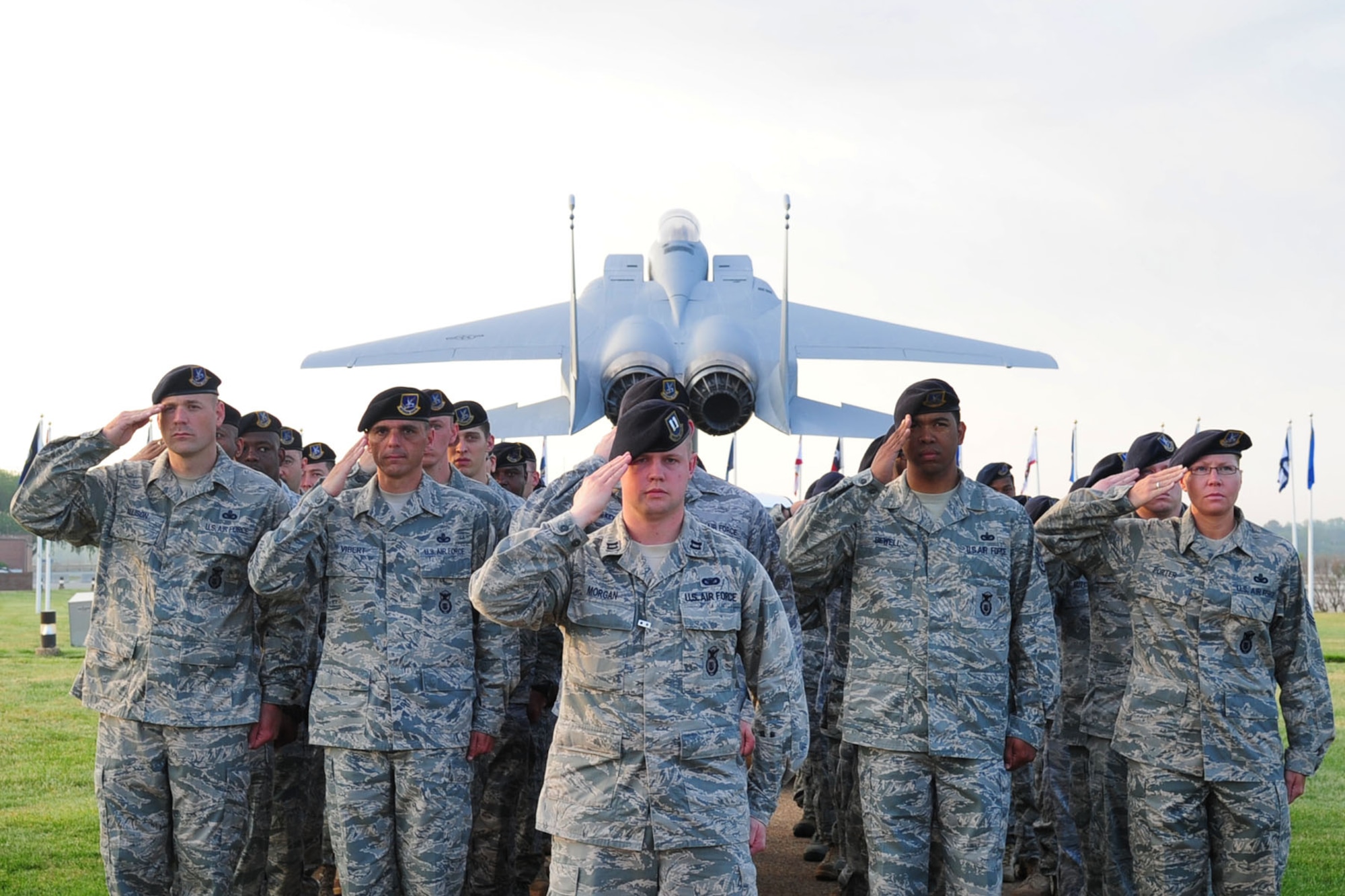 Members of the 633d Security Forces Squadron salute the flag during the Police Officers' Memorial ceremony at Langley Air Force Base, Va., May 16, 2011. The ceremony was held to honor law enforcement personnel who have fallen in the line of duty. (U.S. Air Force photo by Staff Sgt. Ashley Hawkins)(RELEASED)