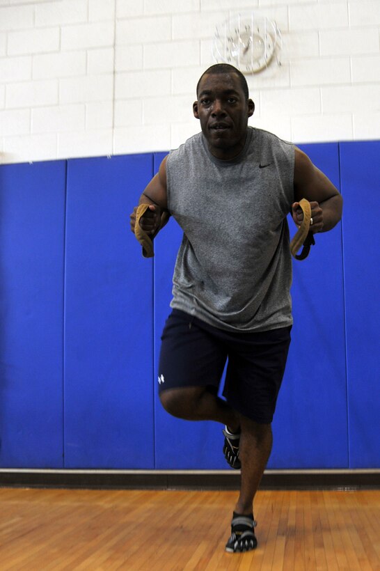 Maj. Freeman Holifield, Air Combat Command bioenvironmental engineer, executes a TRX Suspension Training exercise in the Shellbank Fitness Center at Langley Air Force Base, Va., May 10, 2011. TRX is a type of training in which you use your own body weight and gravity, to build strength, balance, coordination, flexibility, core and joint stability. (U.S. Air Force photo by Airman 1st Class Camilla Elizeu) (RELEASED)  