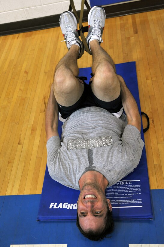 Jim Taccogno , spouse of 1st Lt. Sharee Taccogno, 633d Medical Group inpatient clinical nurse, performs a TRX Suspension Training exercise in the Shellbank Fitness Center at Langley Air Force Base, Va., May 10, 2011. TRX is a type of training in which you use your own body weight and gravity, to build strength, balance, coordination, flexibility, core and joint stability. (U.S. Air Force photo by Airman 1st Class Camilla Elizeu)(RELEASED)  
