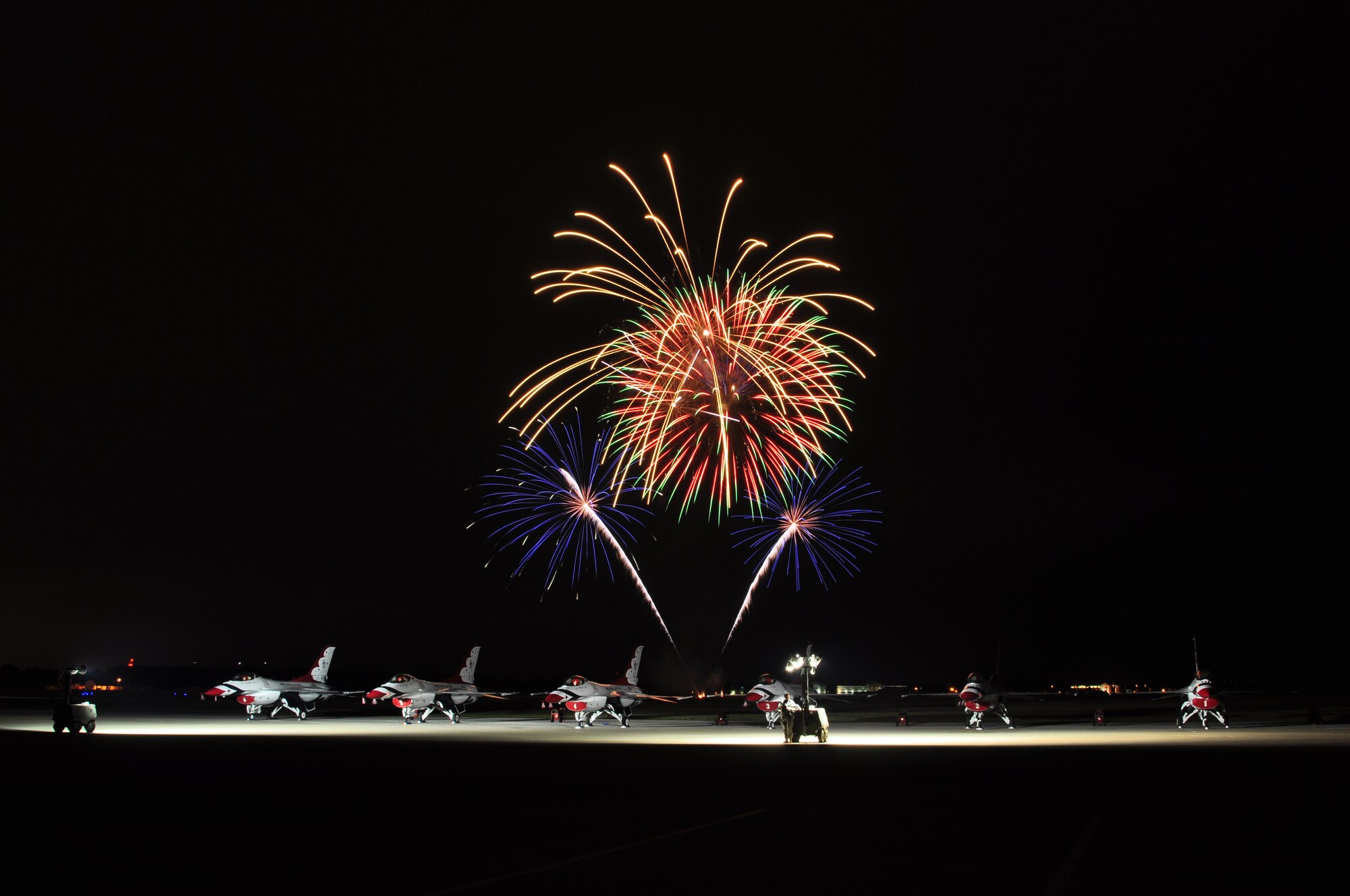 Fireworks bloom above parked Thunderbirds during Air Power over Hampton Roads open house at Langley Air Force Base, Va., May 13, 2011. The U.S. Air Force Thunderbirds headlined the open house and performed precision aerial maneuvers, demonstrating the capabilities of high performance aircraft to the Hampton Roads area.  (U.S. Air Force photo by Senior Airman Jonathan Muller)(RELEASED)

