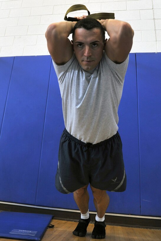 Staff Sgt Keith Miller, 633d Force Support Squadron fitness specialist, executes a TRX Suspension Training exercise in the Shellbank Fitness Center at Langley Air Force Base, Va., May 10, 2011. TRX is a type of training in which you use your own body weight and gravity, to build strength, balance, coordination, flexibility, core and joint stability. (U.S. Air Force photo by Airman 1st Class Camilla Elizeu)(RELEASED) 