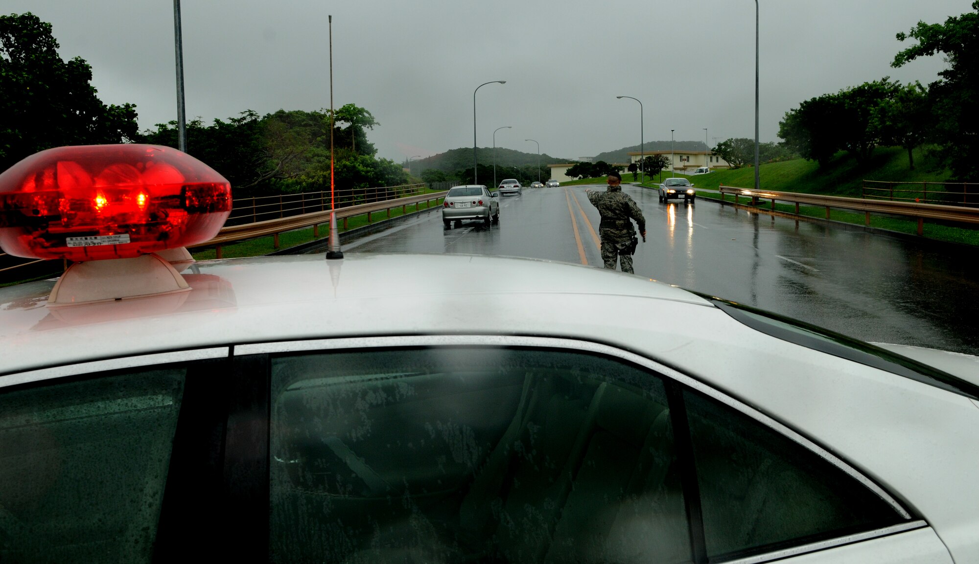 Senior Airman Stephen Biroscak, police services specialist with the 18th Security Forces Squadron, directs traffic after establishing an entry control point during an exercise May 16, at Kadean Air Base, Japan. The Local Operational Readiness Exercise, or LORE, named Beverly High 11-04, uses various training scenarios to train Airmen and prepare them to respond to real-world emergency situations. (U.S. Air Force photo/Airman 1st Class Jarvie Z. Wallace)