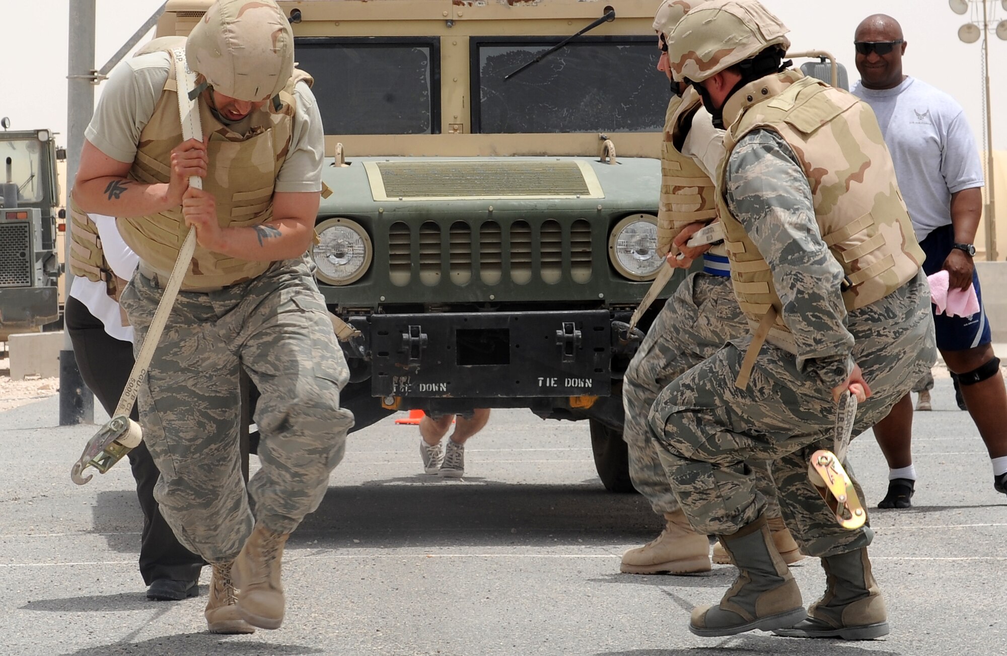 The "AUAB Angels" team pulls a Humvee during the 379th Expeditionary Security Forces Squadron Defenders Challenge competition at an undisclosed location in Southwest Asia, May 15. The team, representing the 379th Air Expeditionary Wing chaplain's office, took first place during the competition. (U.S. Air Force photo/Staff Sgt. Liliana Moreno)