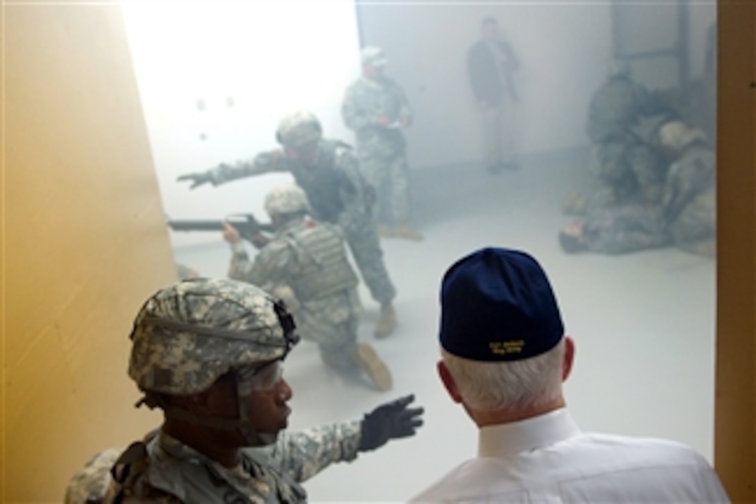 A U.S. Army soldier explains room-clearing techniques to Secretary of Defense Robert M. Gates at Fort Jackson, S.C., on May 12, 2011.  